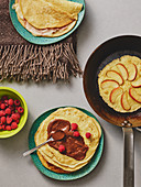 Sweet pancakes with apples, raspberries and chocolate cream and a savoury ham and cheese pancakes