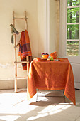 Orange tablecloth and late-summer decorations on table