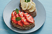 Pan-fried bread topped with peanut butter, strawberries and banana