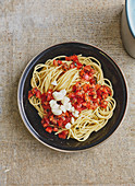 Spaghetti with a cold tomato sauce and mozzarella