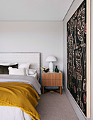 Ethno art in a simple bedroom in shades of gray