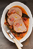 Stuffed pork roulade in a vegetable stock