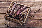 Dry-cured sausages in a wooden box