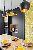 Black and yellow designer kitchen with central dining area