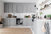 Country-house kitchen with stone-grey cabinets and sisal rug