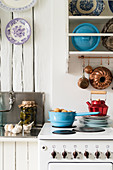 Plate rack above old cooker in vintage kitchen