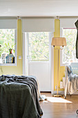 Vintage standard lamp in bedroom with pale yellow walls