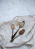 Sesame, sunflower, flax seeds on marble background