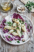 Jerusalem artichokes salad with radicchio salad, nuts and chopped parsley