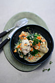 Veal dumplings with a mustard sauce and leafy spinach