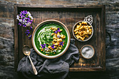Nettle or Spinach Soup with Croutons and Edible Flowers