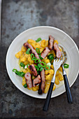 Venison sausages with pumpkin gnocchi and cheese sauce