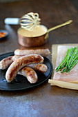 Wild boar sausages with green asparagus