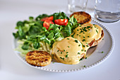 Eggs Benedict with potato fritters and lamb's lettuce