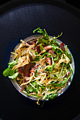 Mixed leaf salad with bacon and soft-boiled egg