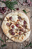 Homemade pizza with grapes and rosemary