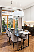 Elegant dining table with upholstered shell chairs