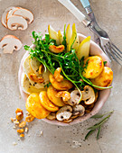 A bowl with polenta fritters, rocket, pears, mozzarella, mushrooms and cashew nuts