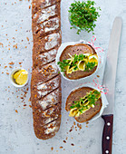 A baguette sandwich with cheese, butter and cress