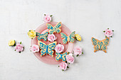 Butterfly biscuits decorated with icing and paper rose