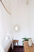 Simple decoration in the exotic bedroom with a four-poster bed