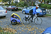Child Cart Pulled by Father's Bicycle