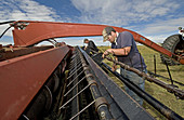 Farmers Repairing Haybine