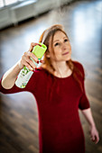 Woman spraying deodorant