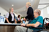 Patients at a hospital reception desk