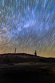 Star trails over mine, time-exposure image