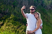 A young couple takes a selfie, Maui, Hawaii, USA