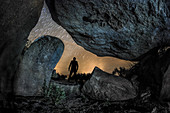 Stargazer framed by dolmen stones