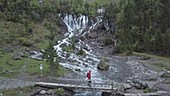 Hiker by Siebenbrunnen falls, Switzerland