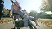 Person pushing child in pushchair
