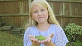 Girl holding frog