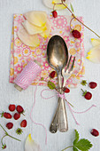Spoon, cake fork and wild strawberries