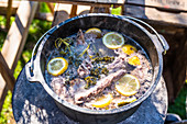 Spare ribs with herbs, lemon and spices in a Dutch oven