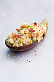 A stuffed aubergine filled with couscous, feta cheese and pine nuts