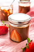 Chocolate mousse with strawberries in a jar