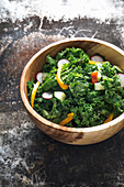 Kale salad with peppers, cucumber and radishes