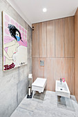 Modern artwork in bathroom with fitted cupboards