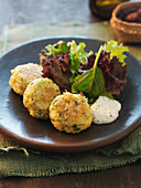 Millet and spring onion fritters with a mixed leaf salad