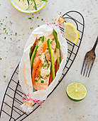 Salmon in parchment paper with asparagus and carrots