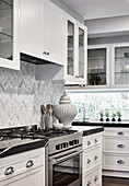 White fitted kitchen with black worksurface