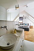Marble washstand with countertop sinks in ensuite bathroom adjoining bedroom