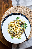 Penne pasta with pesto, walnuts and herbs