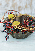 Old cake tin with wreath of twigs and Virginia creeper berries