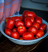 Fresh tomatoes in an enamel bowl