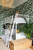 White bunk beds in children's bedroom with jungle-patterned wallpaper