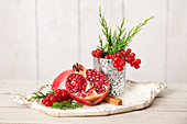 Still life with pomegranate and red currants